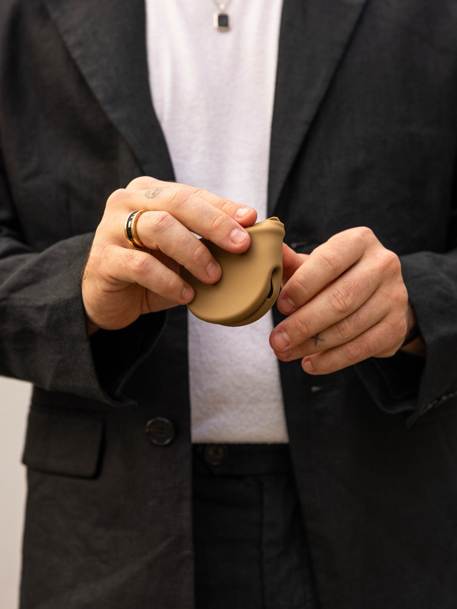 Taupe Icons case held between two hands