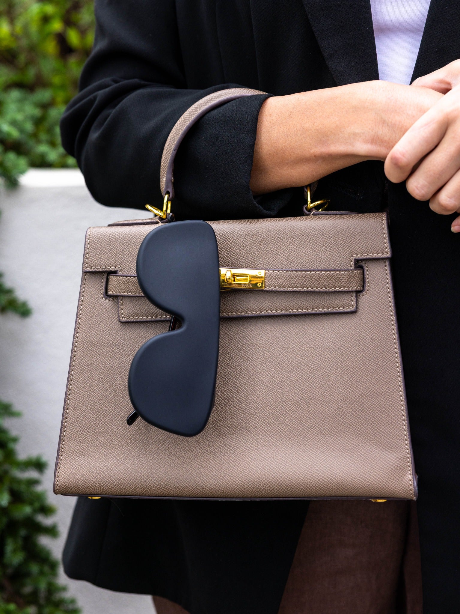 Black Icons case attached to a handbag