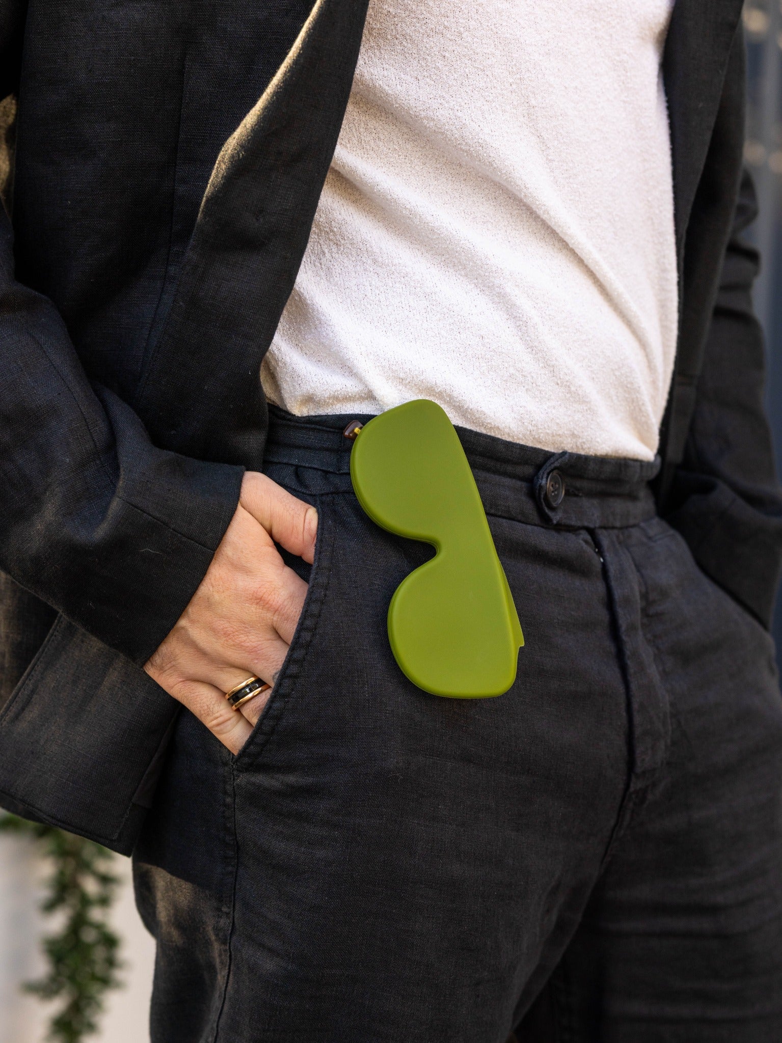 Green Icons case carried at the waistband of dark trousers